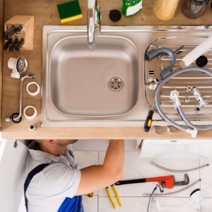 Plumber Installing Kitchen Sink